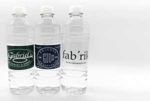 Three clear 16.9 oz water bottles with custom labels
