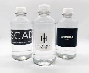 Three water bottles with branded labels