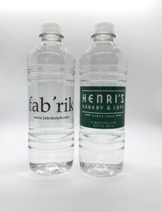 Two clear plastic water bottles with custom labels