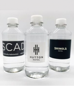 three plastic water bottles with custom labels