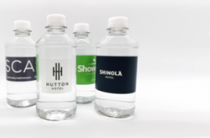 four water bottles with custom promotional labels